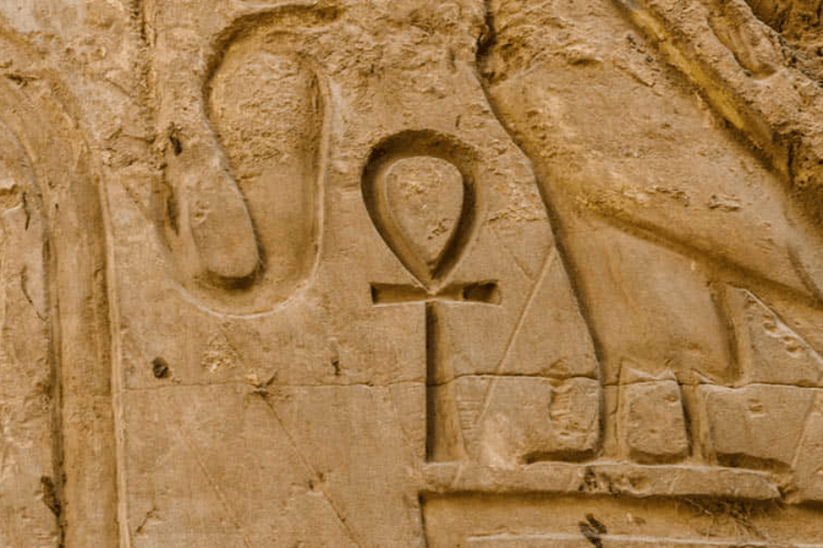 Scholars engaging in a lively debate about the meaning of the Ankh symbol.