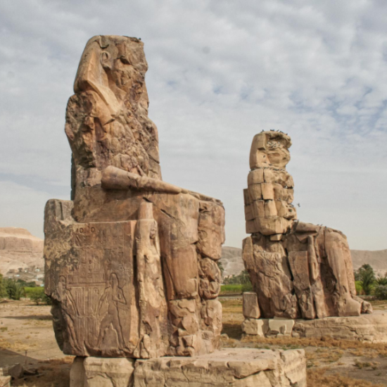The twin statues of the Colossi of Memnon against a bright sky - 14 Days Cairo, Luxor, Aswan, Hurghada, Bahariya Oasis & Alexandria tour