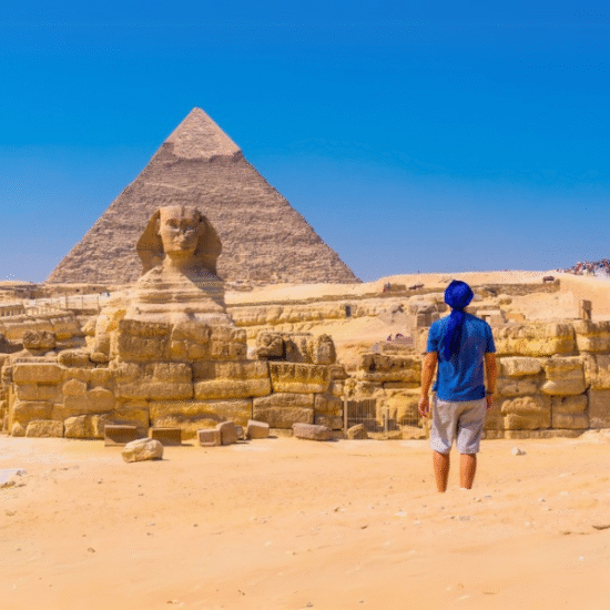 Person standing in front of the Great Pyramids of Giza and the Sphinx, Egypt - 5 Days Cairo and Fayoum Tour including the Grand Egyptian Museum