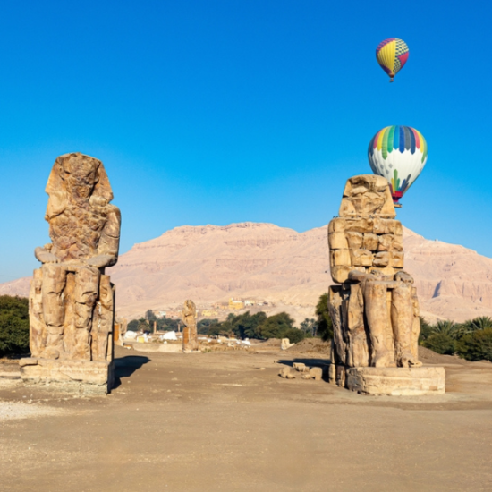 Colossi of Memnon, two giant statues guarding the entrance of the Temple of Amenhotep III.