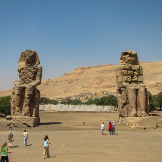 The colossal statues of Memnon standing tall in Luxor, Egypt.
