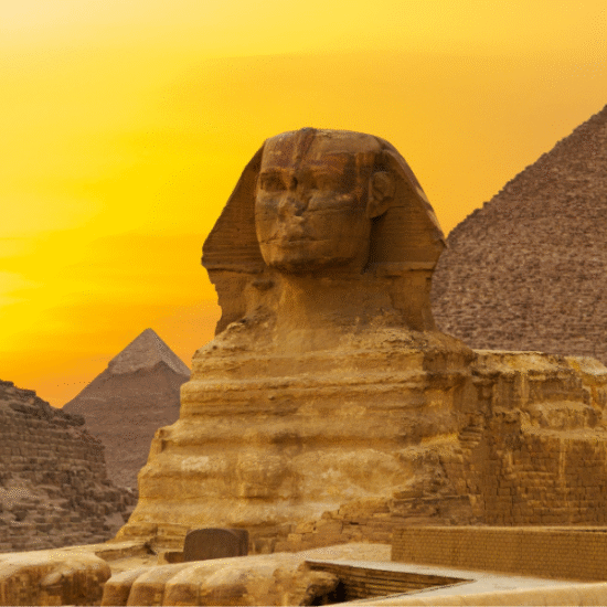 The Pyramids of Giza with the Great Pyramid, desert sands, and the Sphinx in the background - 3 Days Cairo Tour from Luxor by Flight