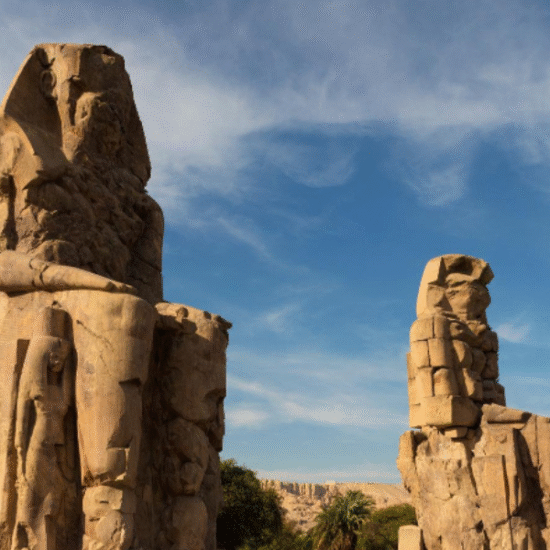 Two massive stone statues of Pharaoh Amenhotep III known as the Colossi of Memnon in Luxor, Egypt - 10 Days Cairo, Hurghada & Nile Cruise Easter Holiday Tour