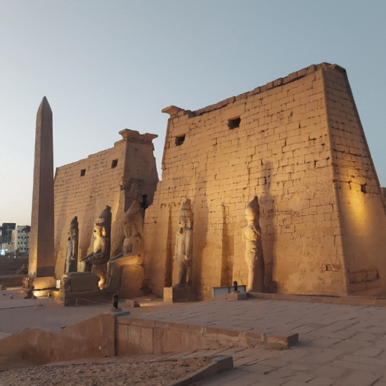 Columns and statues at Luxor Temple at dusk