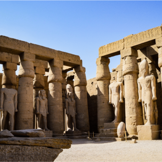 Luxor Temple illuminated at night with ancient statues and columns, Egypt.