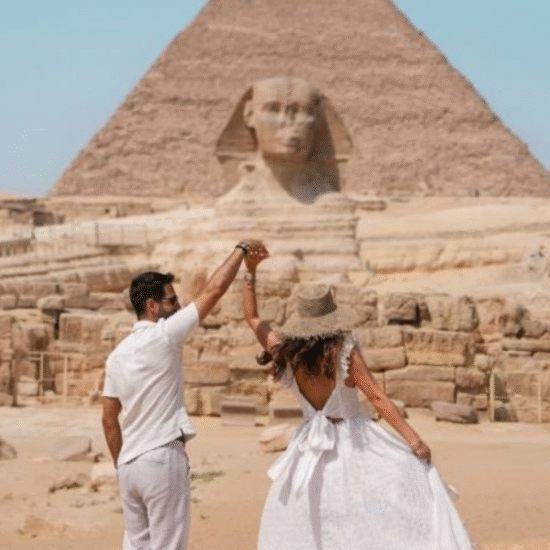 Couple at the Great Sphinx and Pyramids of Giza during honeymoon