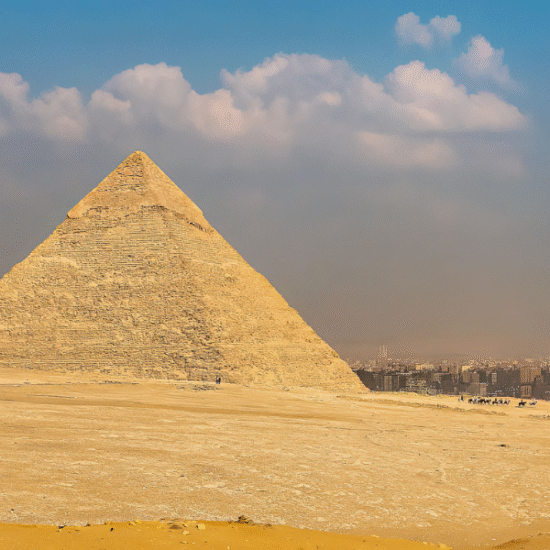 Morning view of the Great Pyramids of Giza with golden sunlight over the desert