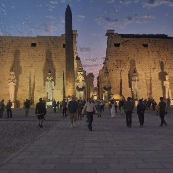 Luxor Temple illuminated at night, showcasing ancient columns and statues in Luxor, Egypt.