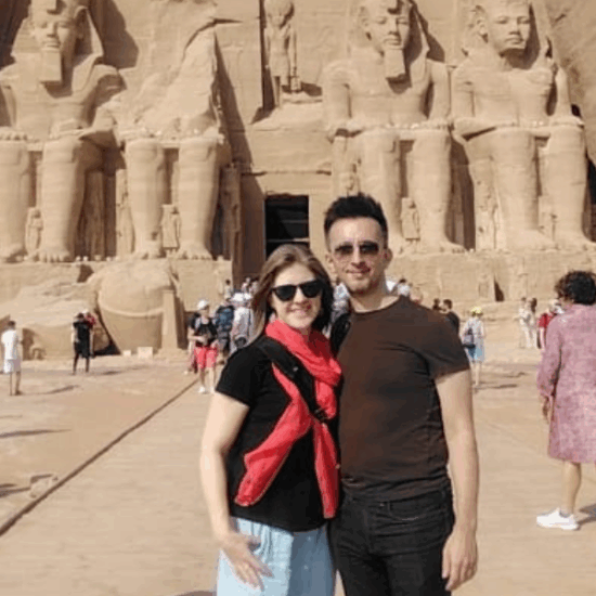 Couple standing in front of Abu Simbel Temple during a private Egypt tour.