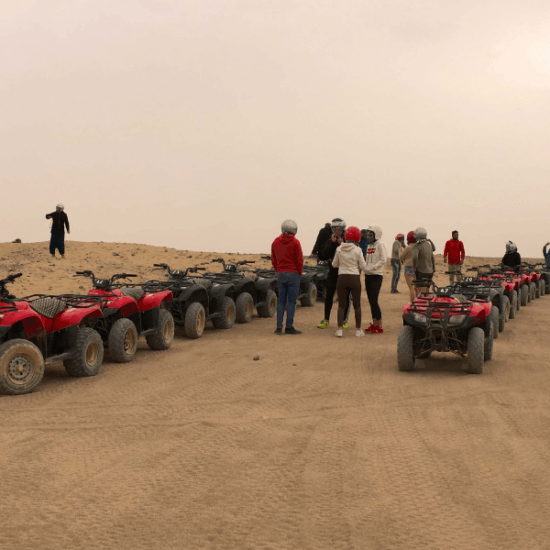 Tourists enjoying a desert safari adventure in the sands near Hurghada, Egypt.