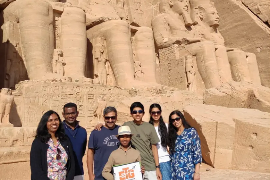 A family standing in front of Abu Simbel Temple in Egypt