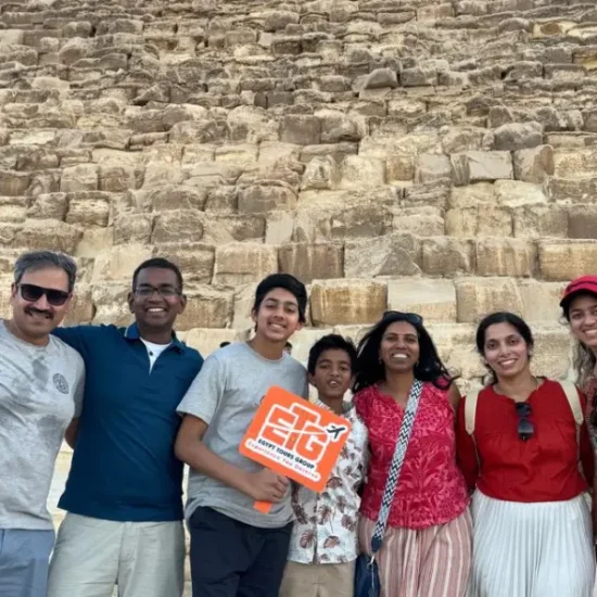 A family standing in front of the Great Pyramid of Giza