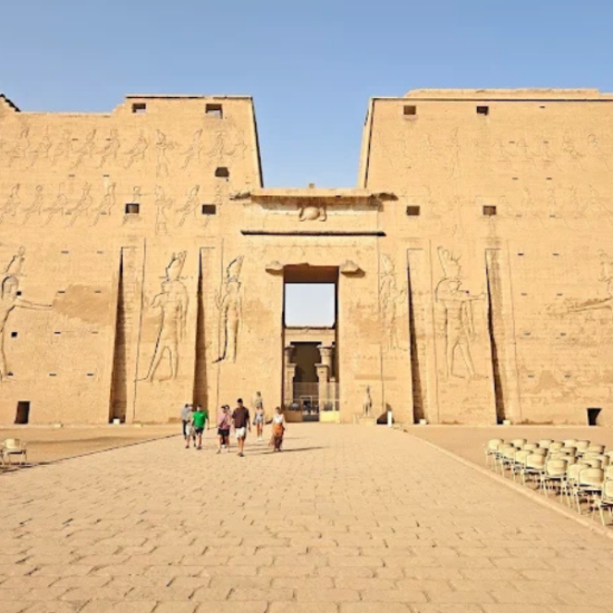 Visitors exploring Edfu Temple by day